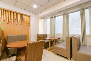 Relax in a stylish room with a seating area, sofa, and large windows.
