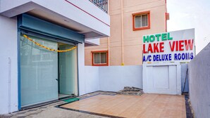 A hotel named "Hotel Lake View" with A/C deluxe rooms, a closed shutter door, and a view of the surrounding area. - Fabhotel Lake View (Pune)
