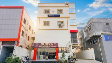 A building with a 'fab hotels' sign and a 'Surya Restaurant & Bar' sign.