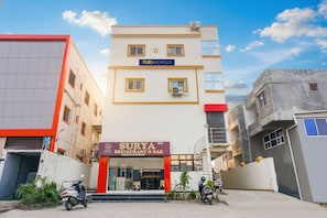 A building with a 'fab hotels' sign and a 'Surya Restaurant & Bar' sign.