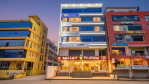Een meerlaags hotel met een opvallend bord waarop 'Laksmi Arcade' staat.
