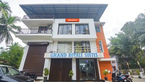 A two-story building with a sign for 'Grand Royale Suites' and a 'Fabexpress' sign above. - FabHotel Holiday Suites - Nr. Benaulim Beach (Benaulim)