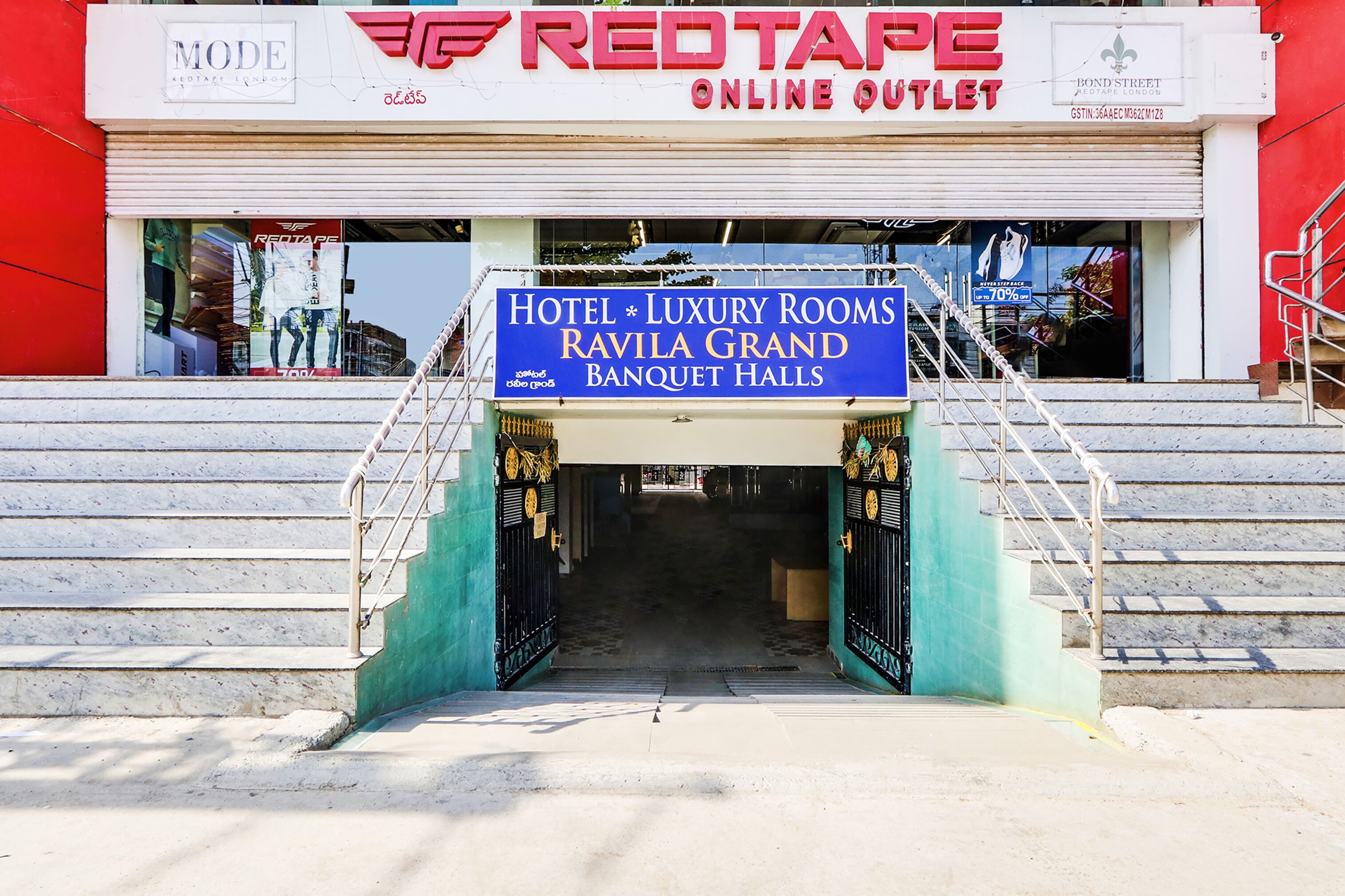 The entrance to Hotel Luxury Rooms Ravila Grand Banquet Halls with a sign above the entrance.