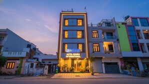 A modern hotel building with a sign for "Hotel Bohra International."