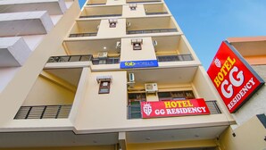 A multi-story hotel building with balconies, air conditioning units, and signage for 'Hotel GG Residency' and 'FabHotels'. - Fabhotel Gg Residency (Mohali)