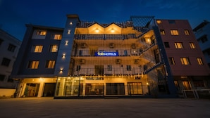 A multi-story hotel with a prominent 'fabHOTELS' sign, outdoor lighting, and a gated entrance. - FabHotel Ivory Pearl Koramangala Bangalore (Bengaluru)