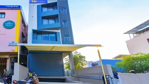 A multi-story building with a modern design, featuring a flat roof and large windows. - FabHotel Shubh Hari (Jaipur)