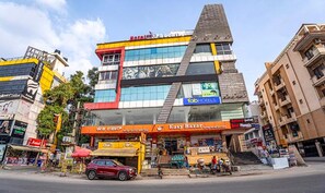 A multi-story hotel with a prominent 'Family Center' sign, a 'Family Center' sign, and a 'Family Center' sign. - Fabhotel Phoenix Horamavu (Bengaluru)