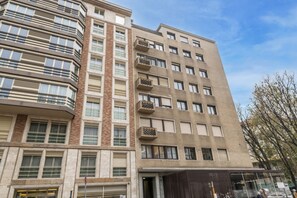 A multi-story building with a mix of brick and concrete facades, large windows, and balconies. - BnButler - De Amicis, 25 (Milano)