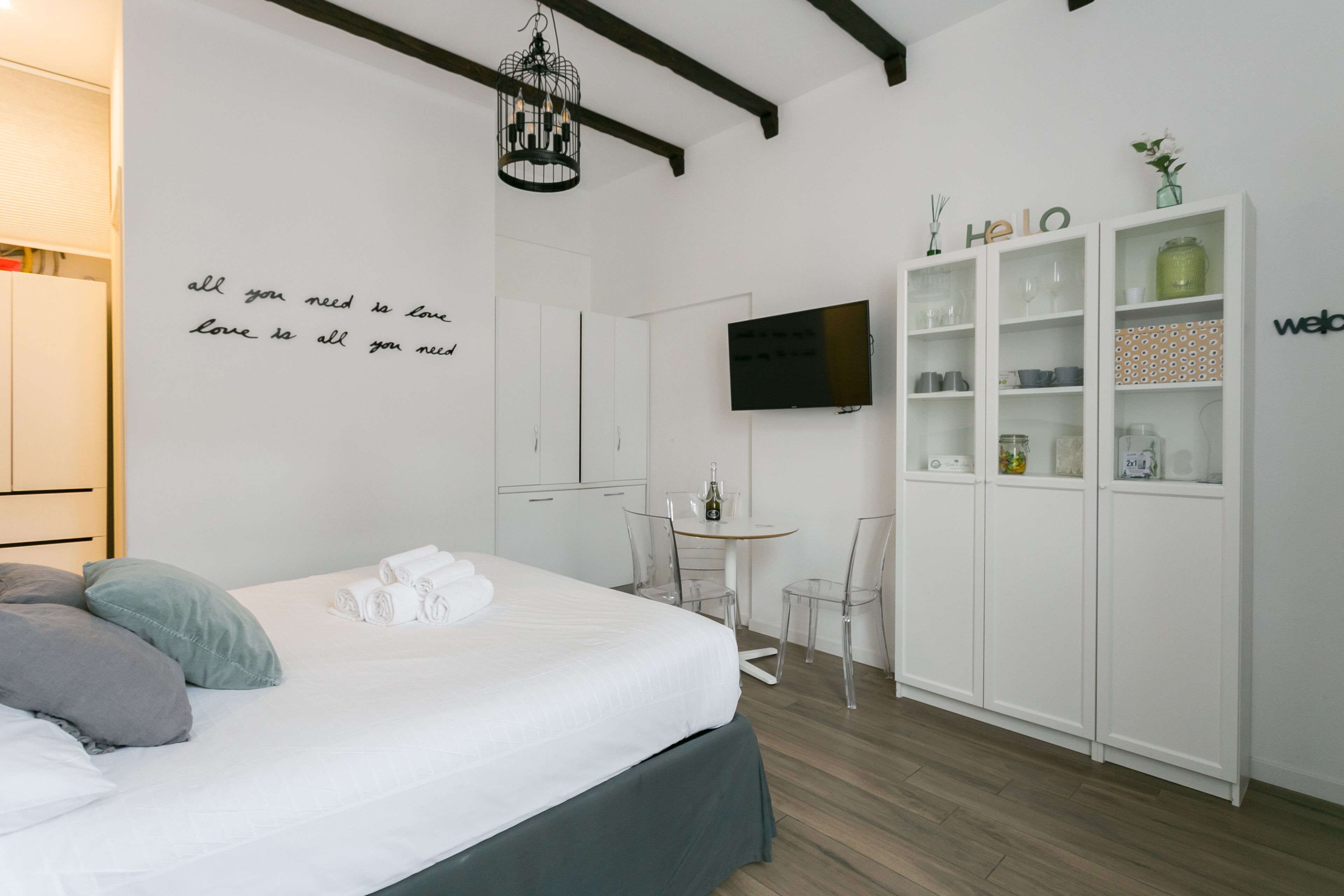 Ein modernes Hotelzimmer mit einem Bett, einem kleinen Tisch und einem Kleiderschrank.