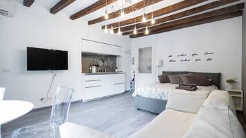 Deluxe Apartment | Living area | 50-inch TV with satellite channels