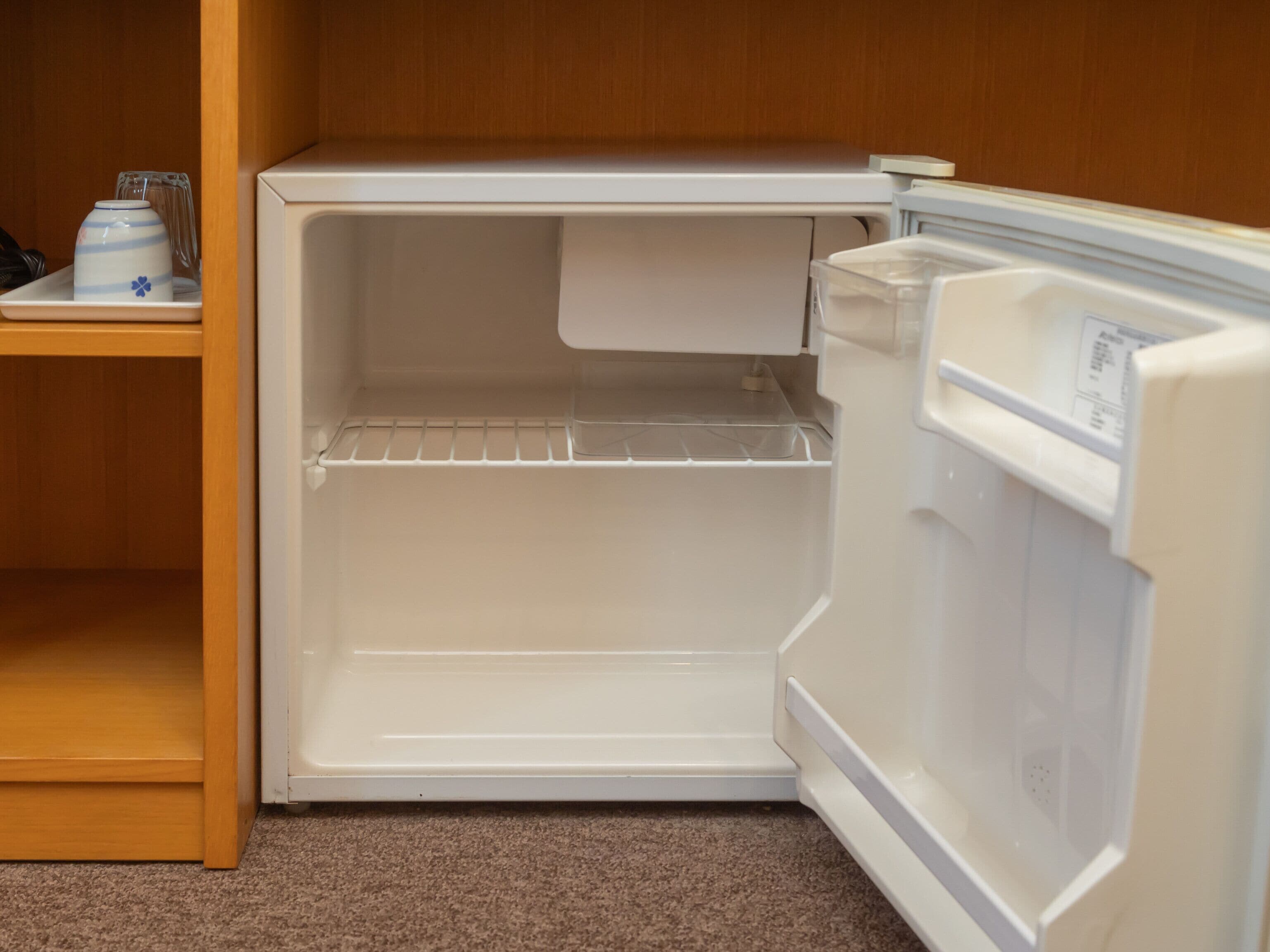 A compact refrigerator with a single door and a freezer compartment.