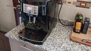 A coffee machine on a granite countertop with a wooden cabinet below. - Family house Cuidad Quesada  Rojales (Ciudad Quesada)