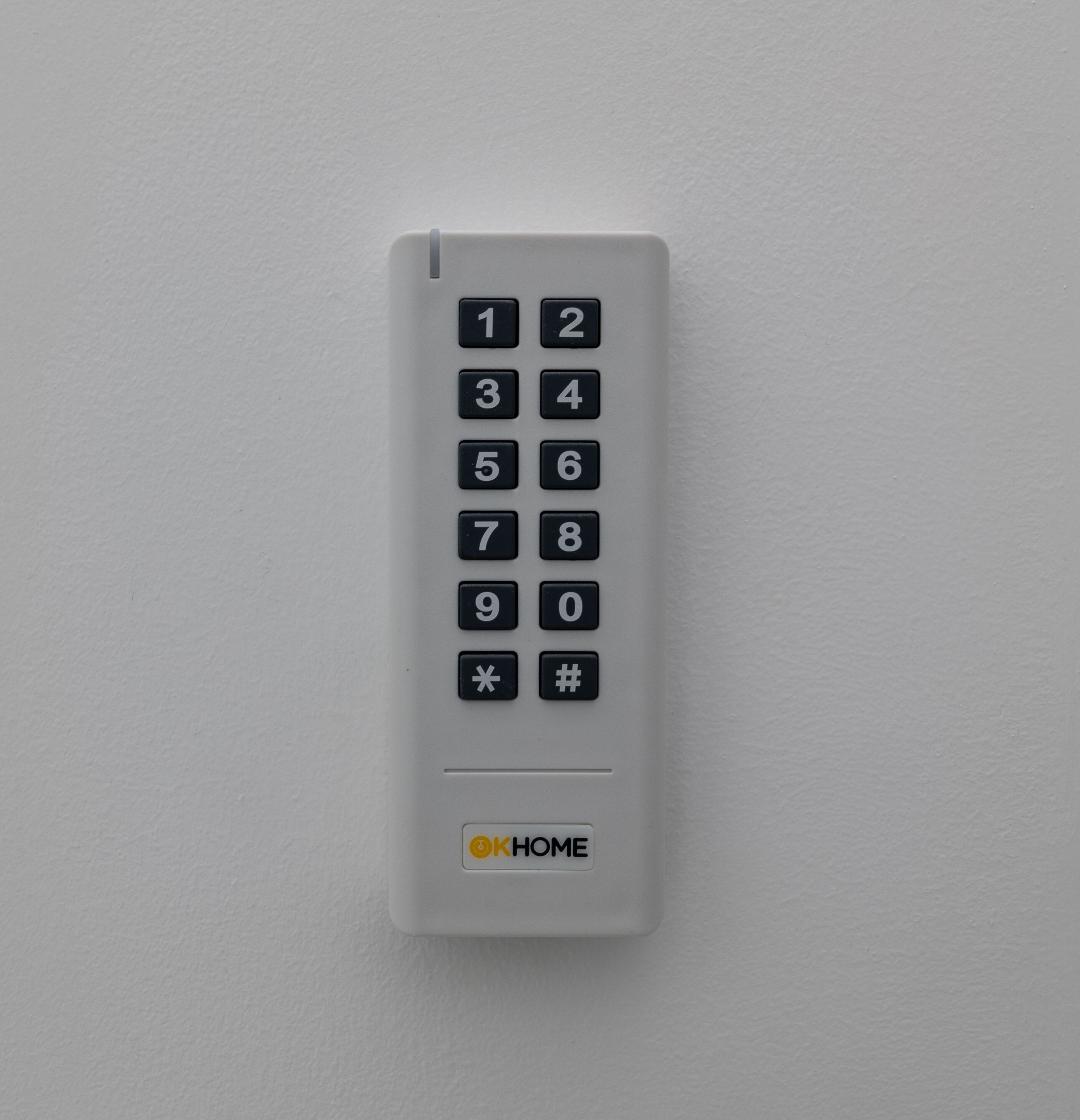 A white keypad with numbers 1-0 and symbols * and #.