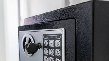 A black safe with a combination dial and a keyhole.