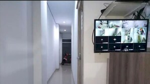 Un couloir équipé d’un écran de surveillance affichant les images de plusieurs caméras.