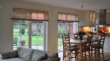 Superior House, Patio, Golf View | Living area | Flat-screen TV