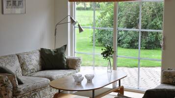 Superior House, Patio, Golf View | Living area | Flat-screen TV