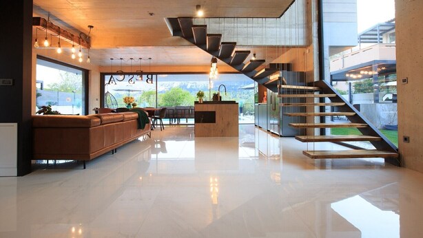 A modern interior with a staircase, a leather sofa, and a dining area. - Luxury villa with swimming pool, sauna and jacuzzi (Baska)
