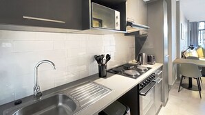 A modern kitchen with stainless steel appliances, a built-in oven, and a large sink.