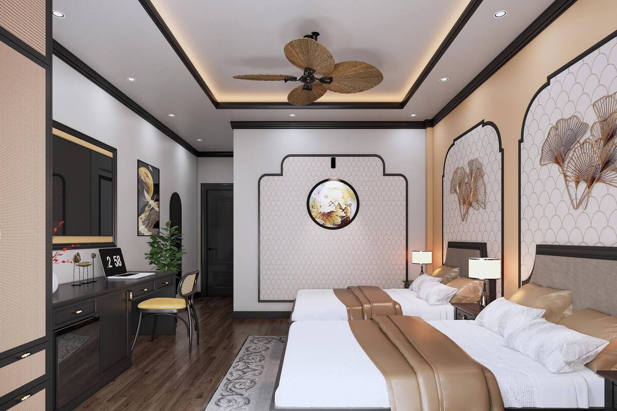 A modern bedroom with a large bed, a desk with a chair, a ceiling fan, and decorative wall art.
