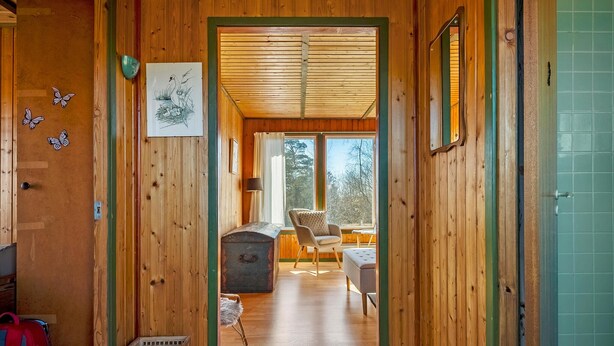 A wooden interior with a hallway leading to a room with a window, a chair, and a table. - 2 bedroom stunning home in Vordingborg (Vordingborg)