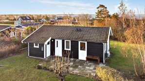 A two-story house with a tiled roof, a small porch, and a stone pathway leading to the entrance. - 2 bedroom stunning home in Vordingborg (Vordingborg)