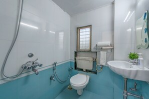 A bathroom with a toilet, sink, and shower. - CosmicStays Venus Villa- Private pool  (Mawal)