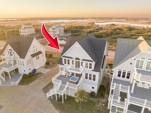 A coastal residential area with houses featuring balconies and a swimming pool. - Island Drive 4158 (North Topsail Beach)
