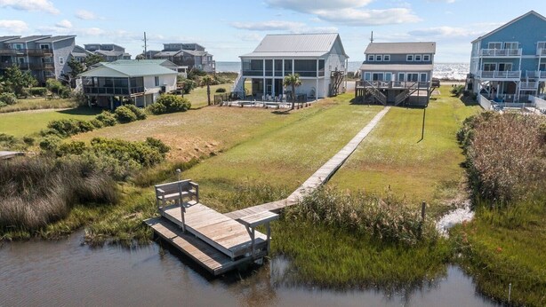 A coastal property with multiple buildings, a dock, and a grassy area. - A Sassy Siren - 3BR Townhouse on Topsail Island with Ocean and Sound Views (North Topsail Beach)