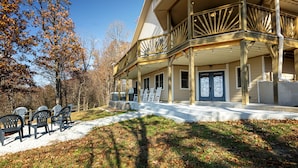 A two-story building with a covered porch and outdoor seating area.