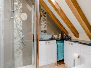 Bathroom features a glass-enclosed shower, sink, and toilet.