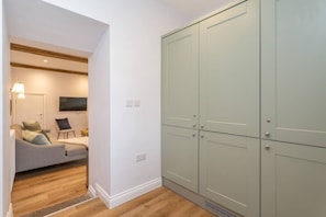 A room with a grey sofa, a flat-screen TV, and a large wardrobe. - The Old Vet’s House, Masham (Masham)