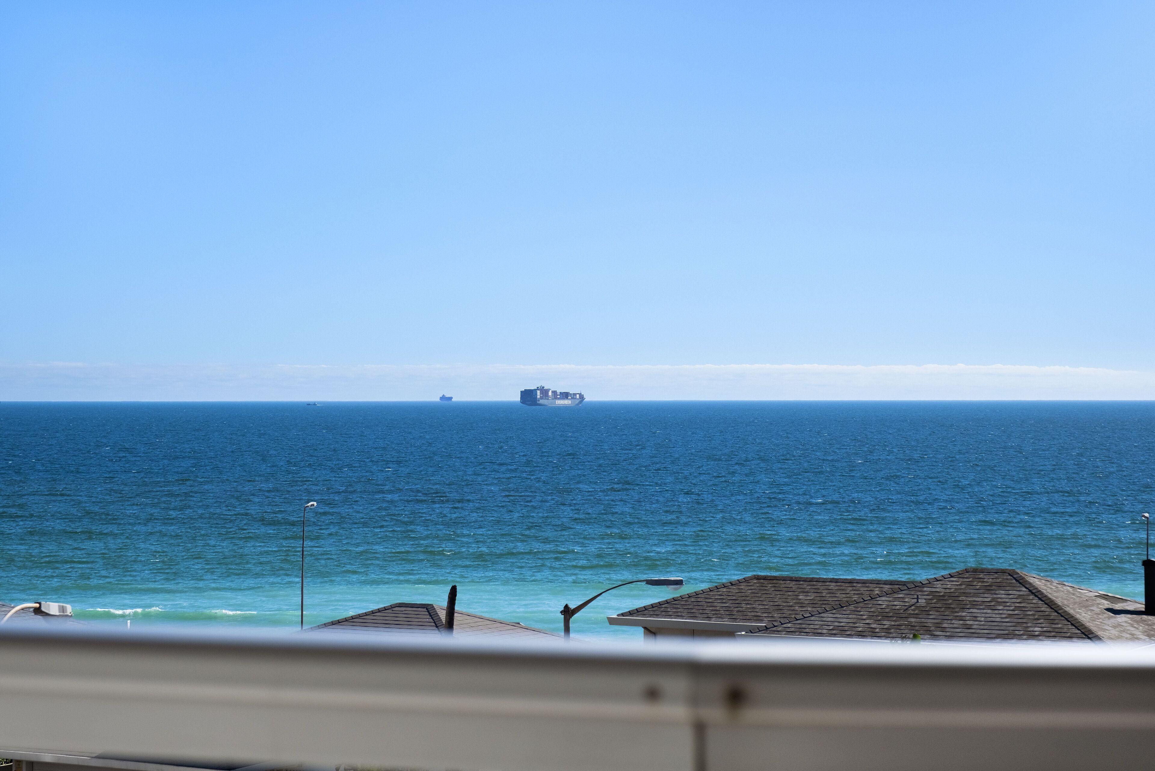 A view of the ocean with a ship in the distance.