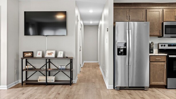 A modern kitchen with stainless steel appliances, a built-in oven, and a microwave.