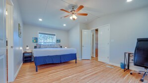 A bedroom with a bed, a ceiling fan, a window, a desk, and a TV. - Pet-friendly Canyon Lake Home ~ 3 Mi to Water! (Canyon Lake)