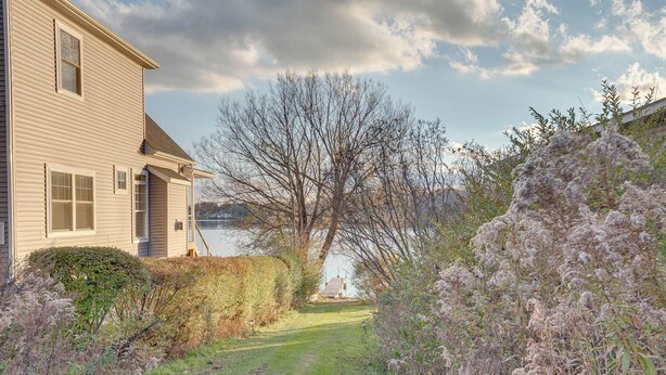 A house with a lawn and a view of a body of water. - Cozy Pennsylvania Home w/ Fire Pit & Dock Access! (Carbondale)