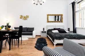A modern bedroom with a bed, a desk, and a chair.
