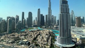 A high-rise building with a curved facade and a prominent sign at the top. - Luxury Burj Royale 4bed With Balcony Burj Khalifa Fountain View (Dubai)