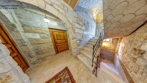 A stone staircase with a wooden door at the top, leading to a lower level. - Tantan Cappadocia House (Nevsehir)