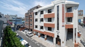 A multi-story hotel with a modern design, featuring a prominent entrance and a visible parking area. - Anook Hotel Daejeon Daeheung (Daejeon)