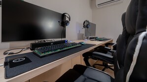 A modern office desk with a large monitor, a mechanical keyboard, headphones, and a mouse. - Anook Hotel Daejeon Daeheung (Daejeon)