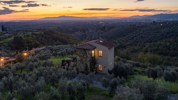 A house surrounded by olive trees on a hillside with a sunset in the background. - Casa Lionardo, Vinci, Florence and Chianti (Vinci)