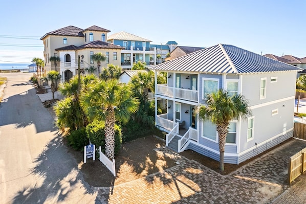 A beachfront property with a two-story house featuring a balcony, surrounded by palm trees and a paved driveway. - Coastal Home w/Private Pool & Volleyball Court! ππ¦πΊ (Miramar Beach)