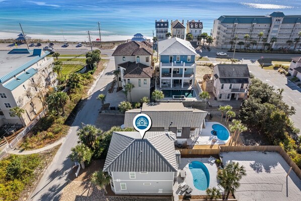 An aerial view of a coastal hotel with multiple buildings, a swimming pool, and a beach view. - Coastal Home w/Private Pool & Volleyball Court! 🏐💦🌺 (Miramar Beach)