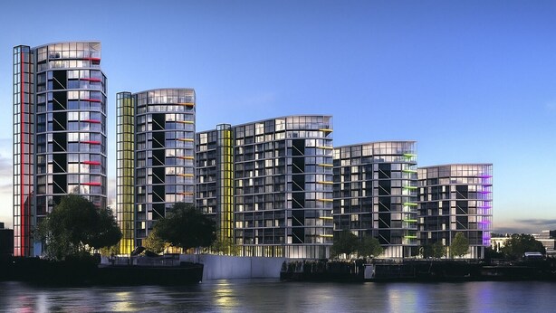 A modern high-rise building with multiple balconies and reflective glass facades, situated by a body of water. - Modern apartment in fantastic Central London (London)