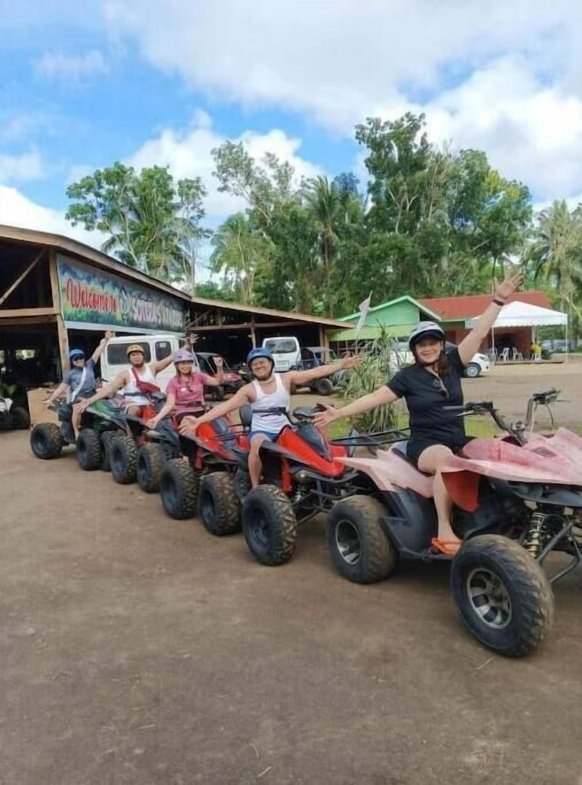 A row of quad bikes parked in front of a building with a sign that reads "Welcome to...".