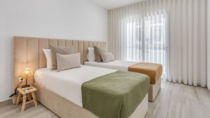 A hotel room with two beds, a nightstand with a lamp, and sheer curtains. - Sublime and Bright 2 BDR Apartment by LovelyStay (Quarteira)