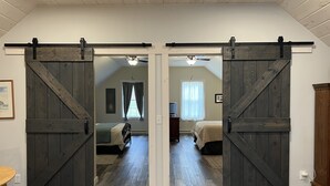 A room with a loft bed, a desk, and a sliding barn door. - Peaceful country getaway close to Cooperstown NY (Oneonta)