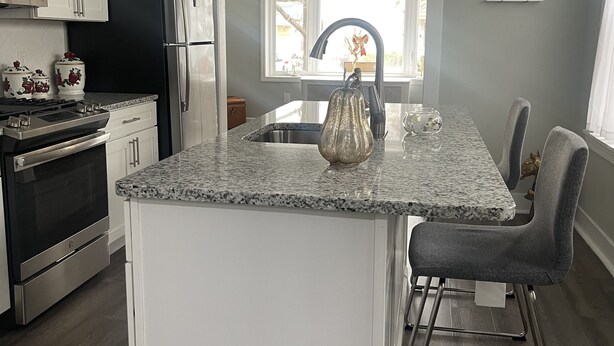 A modern kitchen with white cabinets, stainless steel appliances, a granite countertop, and a pendant light. - COZY SUITE DREAM HOME IN BLOOMFIELD  (Bloomfield)